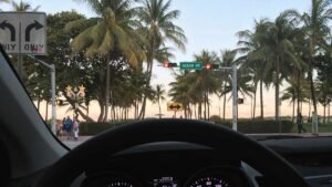 Driving on Ocean Drive in Miami Beach, a high-risk area for rental car accidents.