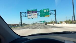 Overhead highway signage on I-95 Miami showing Express Lanes and SunPass Only requirements toward Orlando and Miami.