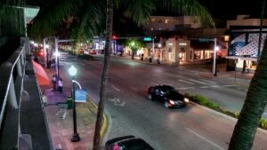 Authentic night view of Washington Avenue from a legal South Beach vacation rental balcony representing a local Miami stay.