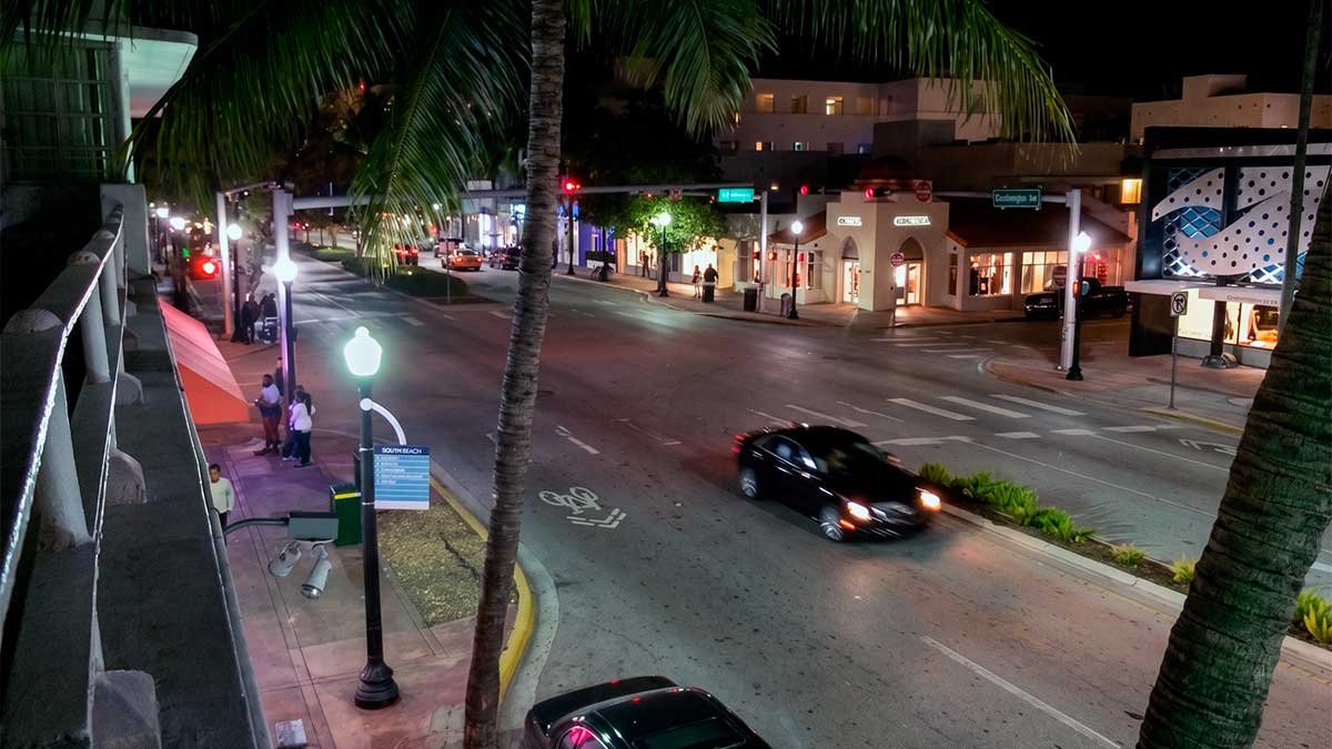 Authentic night view of Washington Avenue from a legal South Beach vacation rental balcony representing a local Miami stay.